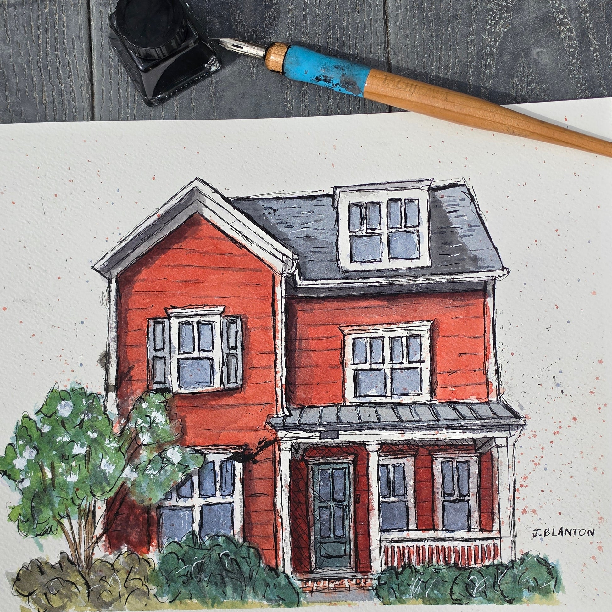 Colorful illustration of a house on paper with a paintbrush next to it.